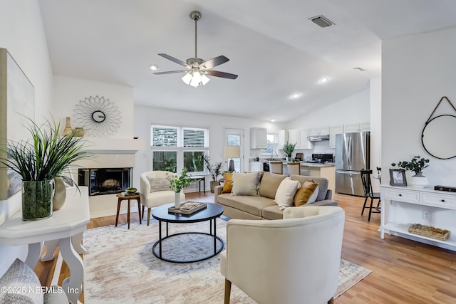 1803 Oakbreeze Ct, Jacksonville Beach, FL 32250 - living area featuring light wood-style flooring, a ceiling fan, lofted ceiling, a premium fireplace, and recessed lighting