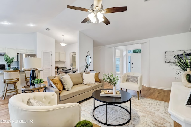 1803 Oakbreeze Ct, Jacksonville Beach, FL 32250 - living room with lofted ceiling, light wood-style floors, and a ceiling fan