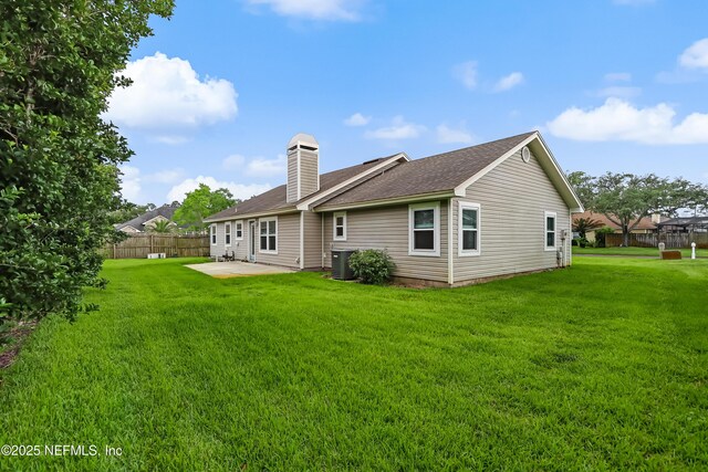 1803 Oakbreeze Ct, Jacksonville Beach, FL 32250 - back of house with a patio area, a chimney, and roof with shingles