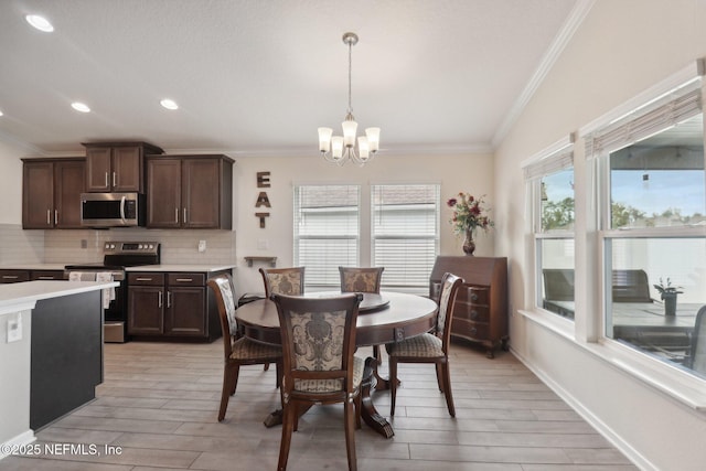 3121 Pretty Cv, Green Cove Springs, FL 32043 - dining space featuring ornamental molding, a chandelier, light wood-style flooring, and recessed lighting