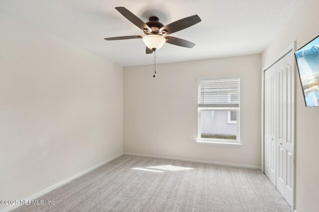 3121 Pretty Cv, Green Cove Springs, FL 32043 - unfurnished bedroom with carpet, a closet, and a ceiling fan