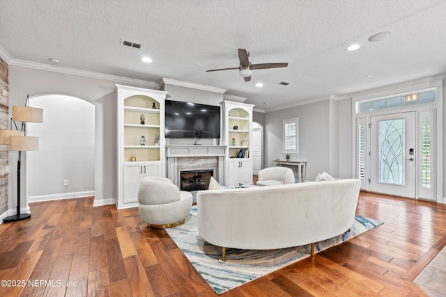 201 History Pl, Saint Augustine, FL 32095 - living area featuring a fireplace, ceiling fan, wood-type flooring, a textured ceiling, and crown molding