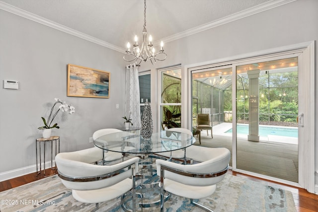 201 History Pl, Saint Augustine, FL 32095 - dining space with wood finished floors, a chandelier, and crown molding