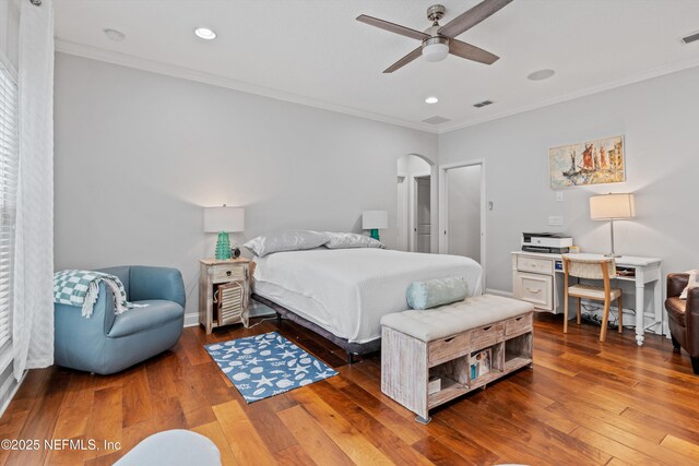 201 History Pl, Saint Augustine, FL 32095 - bedroom with crown molding, hardwood / wood-style flooring, arched walkways, recessed lighting, and a ceiling fan
