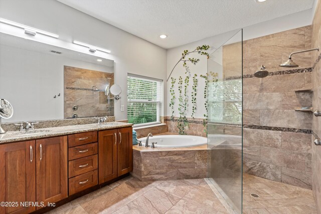 201 History Pl, Saint Augustine, FL 32095 - full bath with a garden tub, double vanity, a walk in shower, recessed lighting, and a textured ceiling