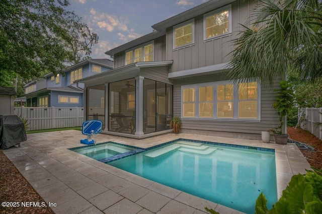 791 Paradise Ln, Atlantic Beach, FL 32233 - view of pool featuring a sunroom, a patio, a fenced backyard, a pool with connected hot tub, and a grill