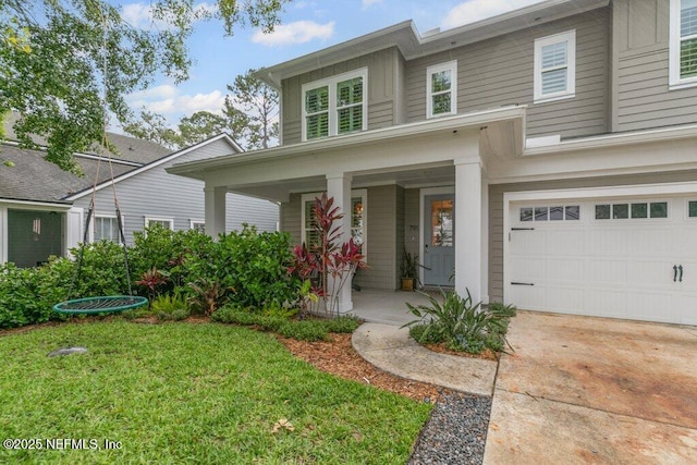 791 Paradise Ln, Atlantic Beach, FL 32233 - view of front of home with a porch, an attached garage, and a front lawn