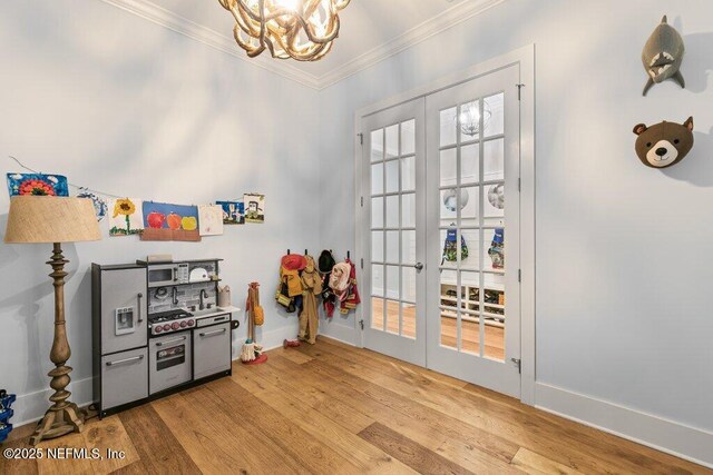 791 Paradise Ln, Atlantic Beach, FL 32233 - recreation room featuring crown molding, a chandelier, wood finished floors, and french doors