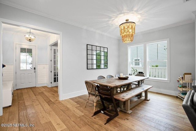 791 Paradise Ln, Atlantic Beach, FL 32233 - dining space featuring a chandelier, light wood-style flooring, plenty of natural light, and ornamental molding