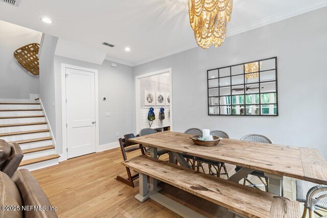 791 Paradise Ln, Atlantic Beach, FL 32233 - dining area featuring stairs, ornamental molding, light wood finished floors, a chandelier, and recessed lighting
