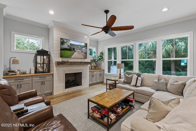 791 Paradise Ln, Atlantic Beach, FL 32233 - living area featuring ceiling fan, light wood-style floors, recessed lighting, a large fireplace, and crown molding