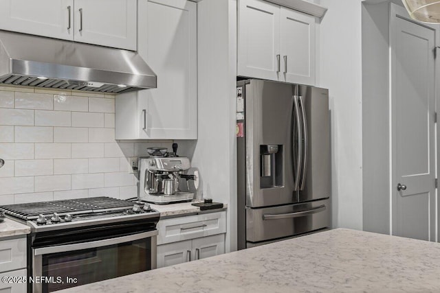 791 Paradise Ln, Atlantic Beach, FL 32233 - kitchen featuring appliances with stainless steel finishes, under cabinet range hood, backsplash, and white cabinetry