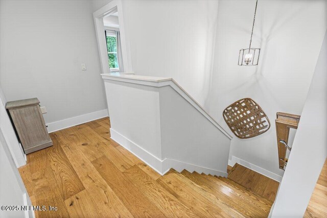 791 Paradise Ln, Atlantic Beach, FL 32233 - stairs featuring wood finished floors and a chandelier