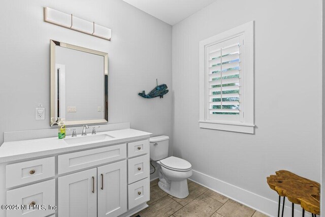 791 Paradise Ln, Atlantic Beach, FL 32233 - half bathroom featuring toilet and vanity