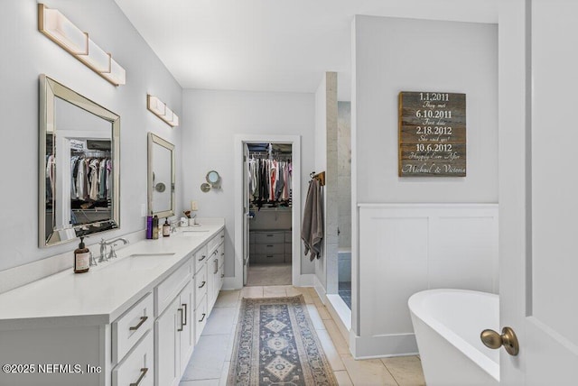 791 Paradise Ln, Atlantic Beach, FL 32233 - bathroom featuring double vanity, a walk in closet, a freestanding bath, and tile patterned flooring