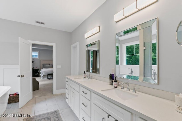 791 Paradise Ln, Atlantic Beach, FL 32233 - bathroom featuring a freestanding bath, double vanity, ensuite bath, and tile patterned floors