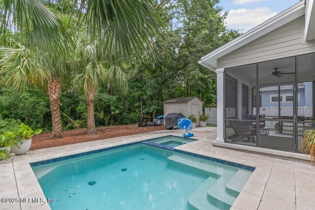 791 Paradise Ln, Atlantic Beach, FL 32233 - view of pool featuring a shed, a sunroom, ceiling fan, a patio area, and a pool with connected hot tub