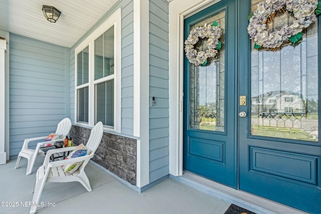 207 Hertford Bridge Way, Saint Johns, FL 32259 - view of exterior entry with stone siding, covered porch, and french doors