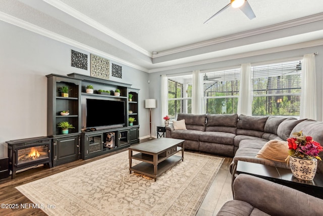 207 Hertford Bridge Way, Saint Johns, FL 32259 - living area with crown molding, light wood-style floors, a ceiling fan, a textured ceiling, and a raised ceiling