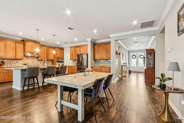 207 Hertford Bridge Way, Saint Johns, FL 32259 - dining space with recessed lighting, dark wood-style flooring, and crown molding