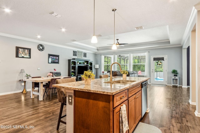 207 Hertford Bridge Way, Saint Johns, FL 32259 - kitchen featuring a raised ceiling, dark wood-style flooring, brown cabinetry, open floor plan, and ornamental molding