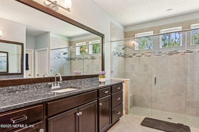 207 Hertford Bridge Way, Saint Johns, FL 32259 - bathroom featuring plenty of natural light, a stall shower, vanity, and a textured ceiling