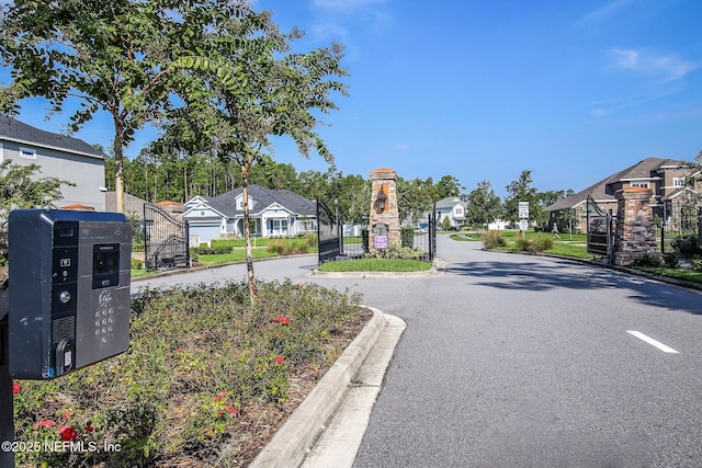 207 Hertford Bridge Way, Saint Johns, FL 32259 - view of asphalt road featuring a residential view, curbs, and a gated entry