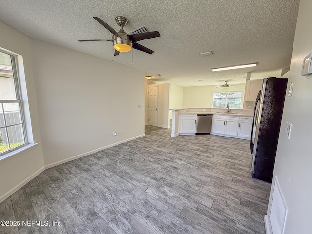 1736 Ashwood Cir, Middleburg, FL 32068 - unfurnished living room with ceiling fan, a textured ceiling, and light wood-style flooring