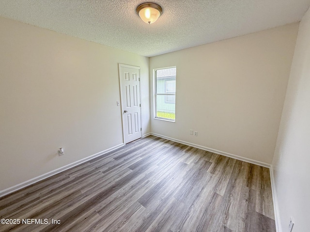 1736 Ashwood Cir, Middleburg, FL 32068 - unfurnished room with wood finished floors and a textured ceiling