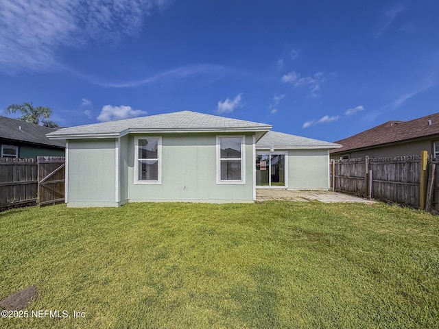 1736 Ashwood Cir, Middleburg, FL 32068 - rear view of property with a fenced backyard, a patio, and a shingled roof