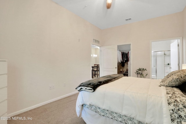 218 Larkin Pl Unit 101, Saint Johns, FL 32259 - bedroom with carpet floors, a walk in closet, a closet, connected bathroom, and a chandelier