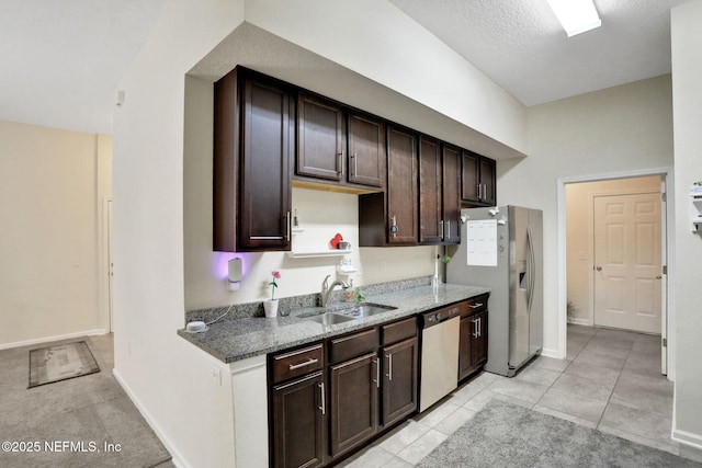 218 Larkin Pl Unit 101, Saint Johns, FL 32259 - kitchen with appliances with stainless steel finishes, dark brown cabinetry, stone counters, and light tile patterned floors