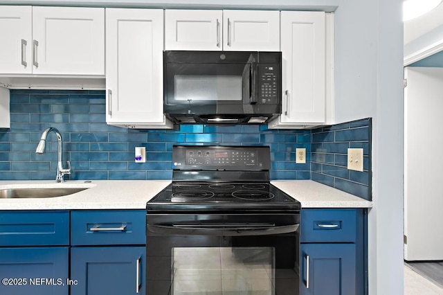 6202 Columbine Dr, Jacksonville, FL 32211 - kitchen featuring black appliances, blue cabinetry, light countertops, and white cabinets
