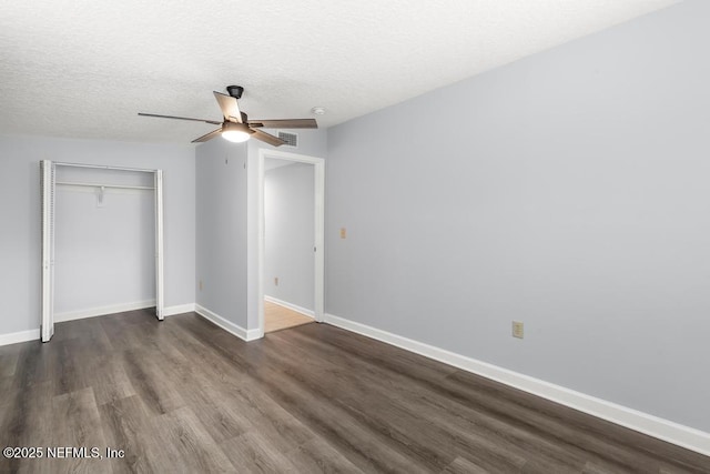 6202 Columbine Dr, Jacksonville, FL 32211 - unfurnished bedroom featuring dark wood-style flooring, a closet, a textured ceiling, and ceiling fan