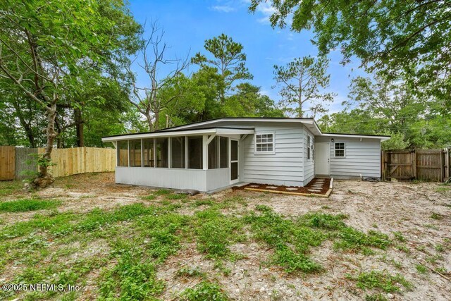 6202 Columbine Dr, Jacksonville, FL 32211 - rear view of property with a sunroom and a fenced backyard