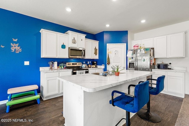65490 Crested Heron Ct, Yulee, FL 32097 - kitchen featuring appliances with stainless steel finishes, dark wood finished floors, light countertops, and recessed lighting