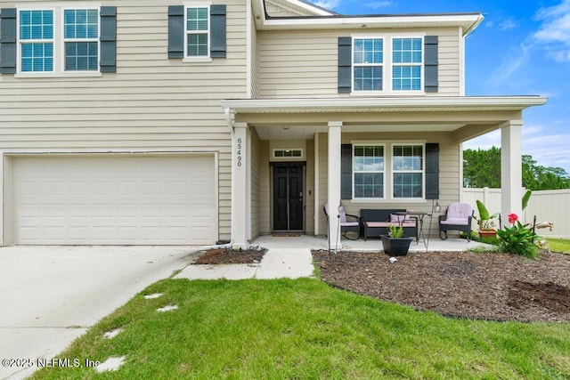 65490 Crested Heron Ct, Yulee, FL 32097 - traditional-style home with a porch, an attached garage, and driveway