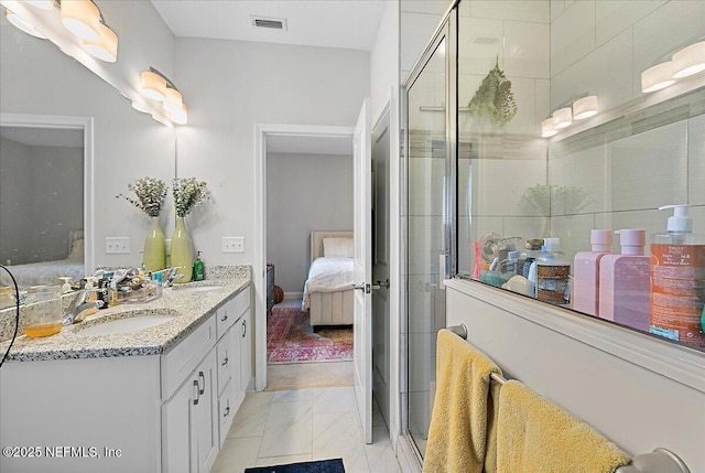 850 Bruen St, Saint Augustine, FL 32084 - ensuite bathroom featuring double vanity, a stall shower, and marble finish floors