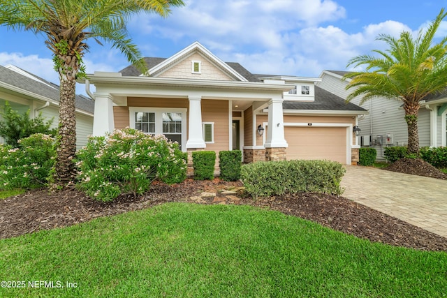 91 Paradise Valley Dr, Ponte Vedra, FL 32081 - craftsman inspired home with a garage, decorative driveway, stone siding, roof with shingles, and a front yard