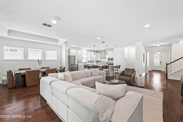 91 Paradise Valley Dr, Ponte Vedra, FL 32081 - living area with dark wood-type flooring, stairs, ornate columns, and recessed lighting