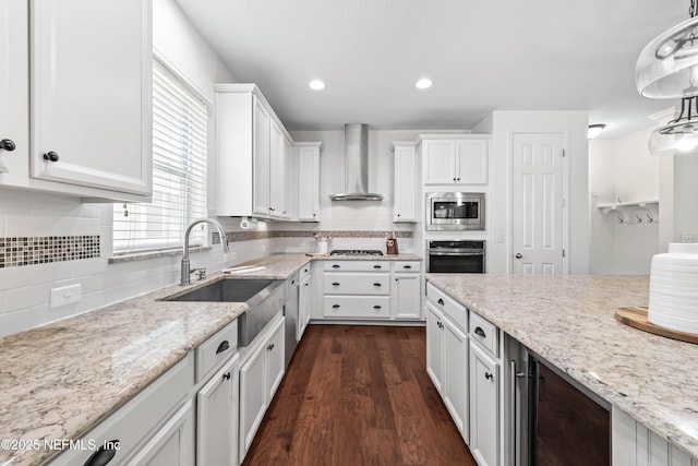91 Paradise Valley Dr, Ponte Vedra, FL 32081 - kitchen featuring wall chimney range hood, stainless steel appliances, white cabinets, dark wood-style floors, and decorative backsplash