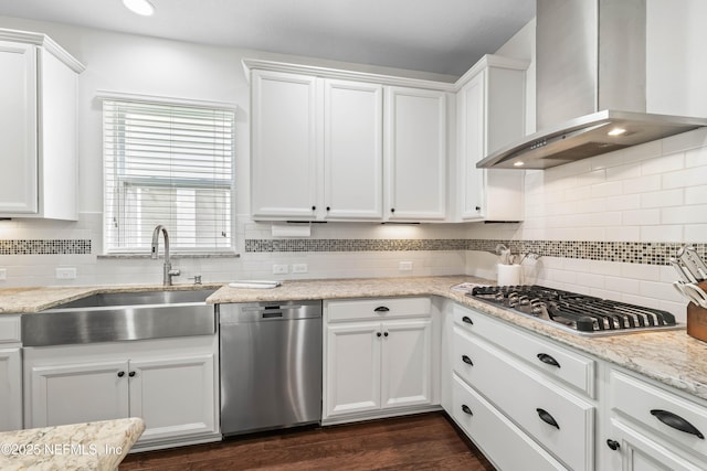 91 Paradise Valley Dr, Ponte Vedra, FL 32081 - kitchen with wall chimney range hood, stainless steel appliances, white cabinets, decorative backsplash, and light stone counters