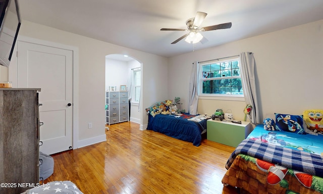 90 SE Forest St, Keystone Heights, FL 32656 - bedroom featuring arched walkways, light wood-type flooring, and ceiling fan