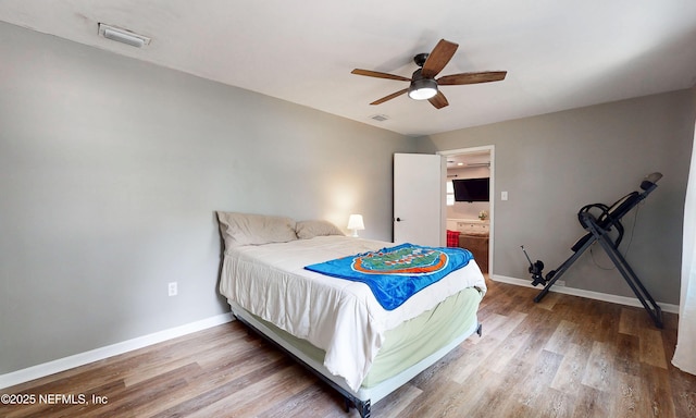 90 SE Forest St, Keystone Heights, FL 32656 - bedroom with wood finished floors, connected bathroom, and ceiling fan