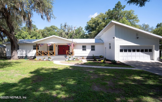 90 SE Forest St, Keystone Heights, FL 32656 - view of front of property featuring a garage, concrete driveway, a front lawn, and covered porch