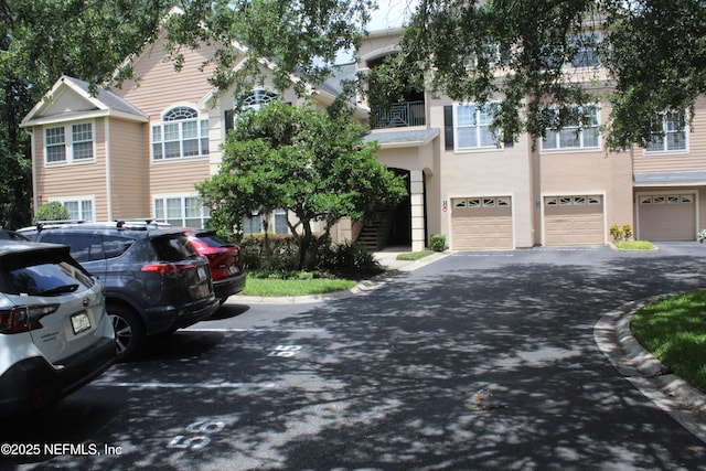 13810 Sutton Park Dr N Unit 528, Jacksonville, FL 32224 - view of property featuring an attached garage, driveway, and stucco siding