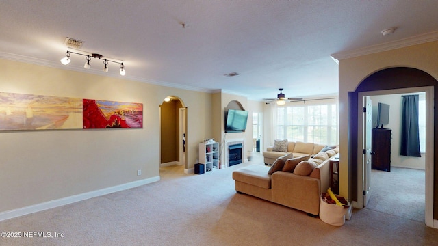 13810 Sutton Park Dr N Unit 528, Jacksonville, FL 32224 - carpeted living area featuring arched walkways, ornamental molding, a ceiling fan, and a fireplace