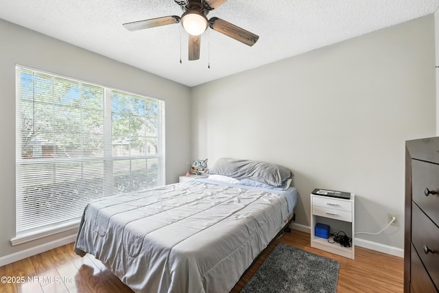 3172 Twilight Ct, Middleburg, FL 32068 - bedroom featuring light wood-type flooring, ceiling fan, and a textured ceiling