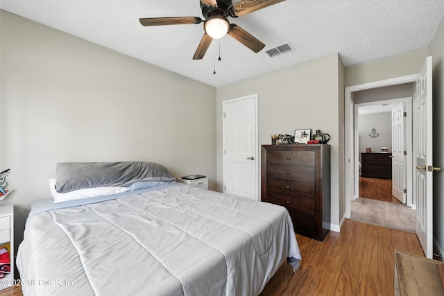 3172 Twilight Ct, Middleburg, FL 32068 - bedroom with wood finished floors, ceiling fan, and a textured ceiling