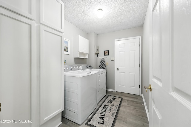 3172 Twilight Ct, Middleburg, FL 32068 - laundry room with cabinet space, washer and dryer, a textured ceiling, and light wood-type flooring